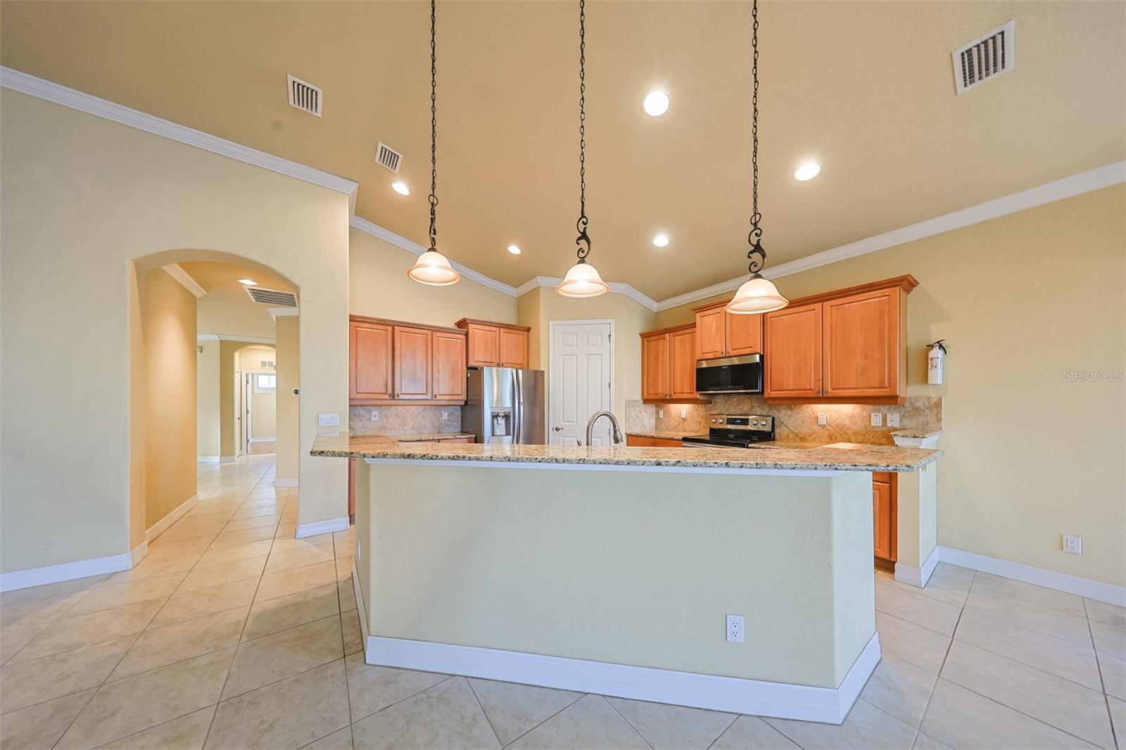 Beautiful soft earth tones in this kitchen, along with lots of lighting and space help to make the task of cooking and preparing that perfect meal enjoyable.  All the while having water and golf course views to enjoy.
