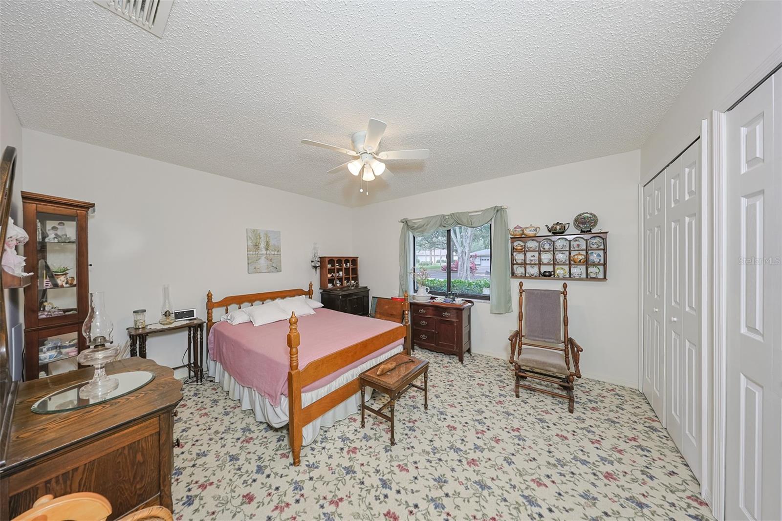 GUEST BEDROOM WITH WELCOMING CARPET, DOUBLE CLOSETS