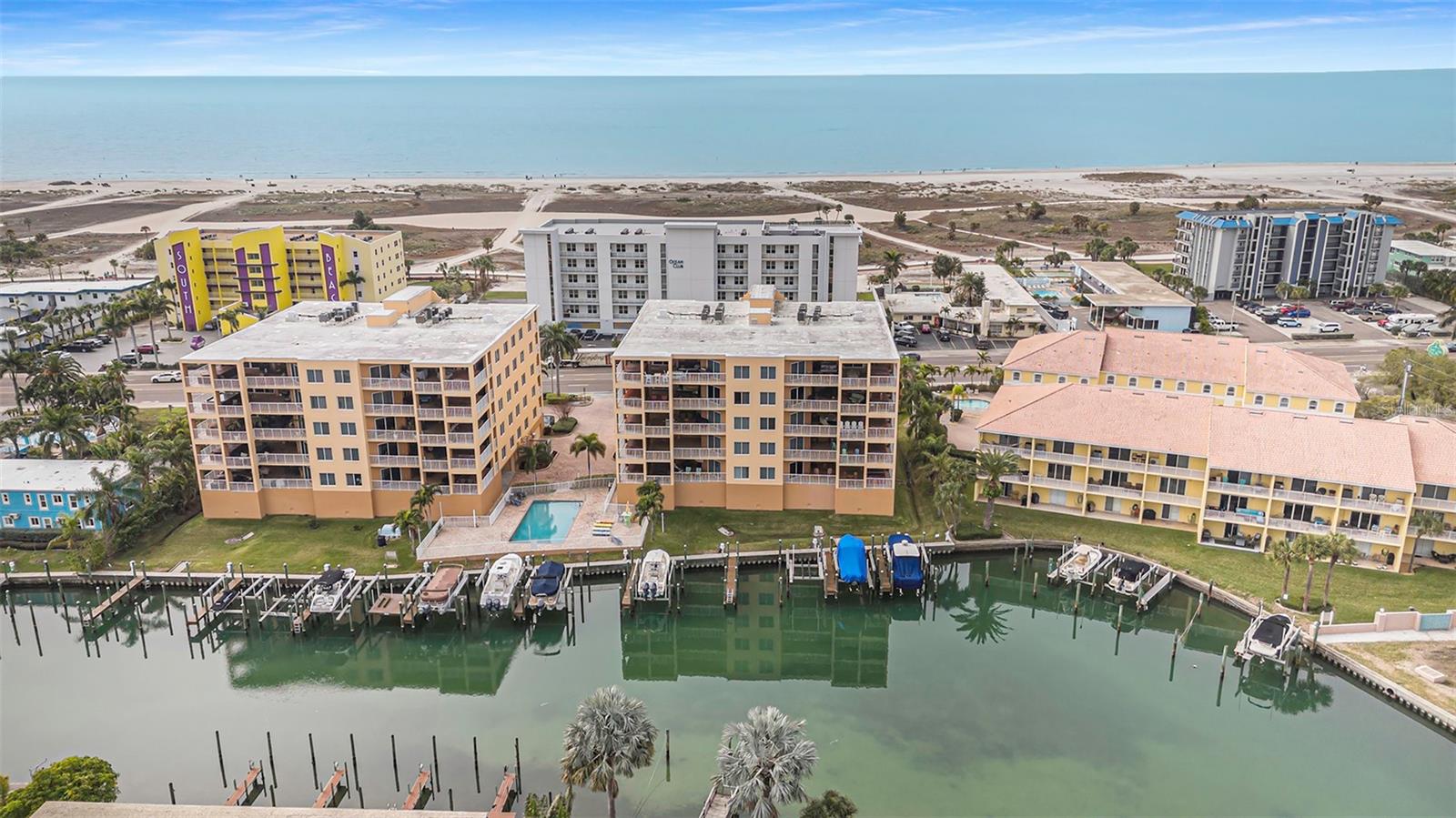 Walk across the street and spend the day on the beach, dock your boat in your deeded slip, and enjoy over 3700 sf located between the Gulf of Mexico and the intracoastal waterway!  This. Is. Florida.