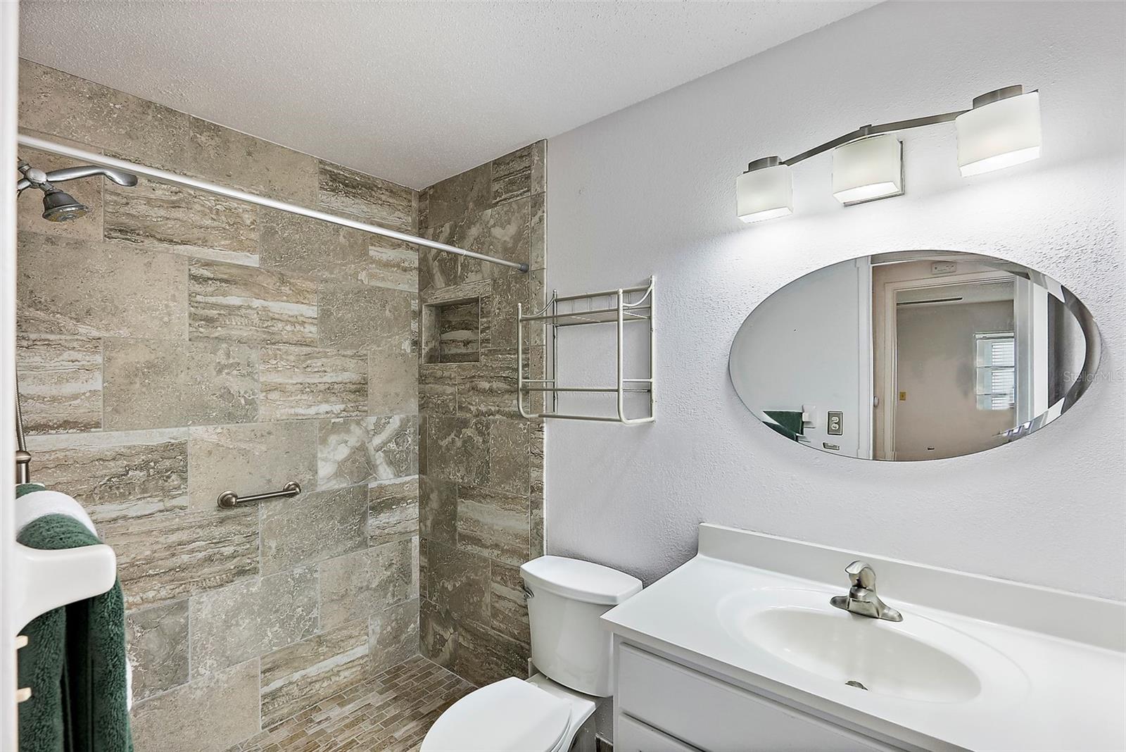 Renovated bath with walk-in shower.