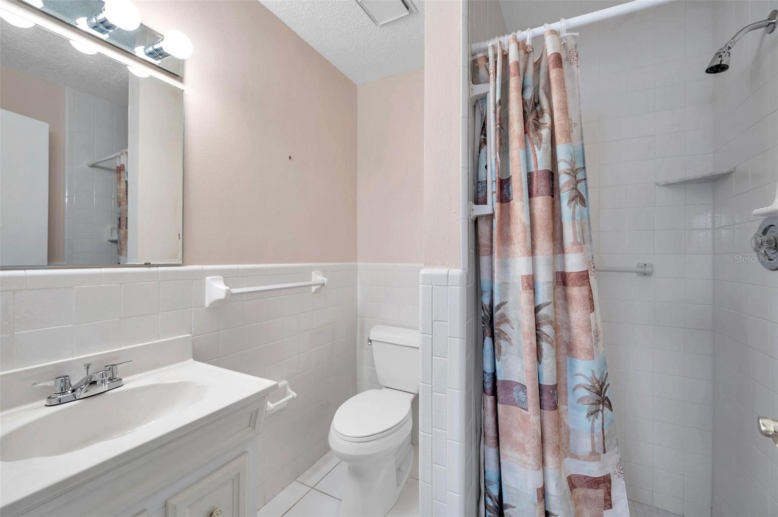 Primary bathroom has shower, no tub.  This bath was remodeled with newer vanity and commode.