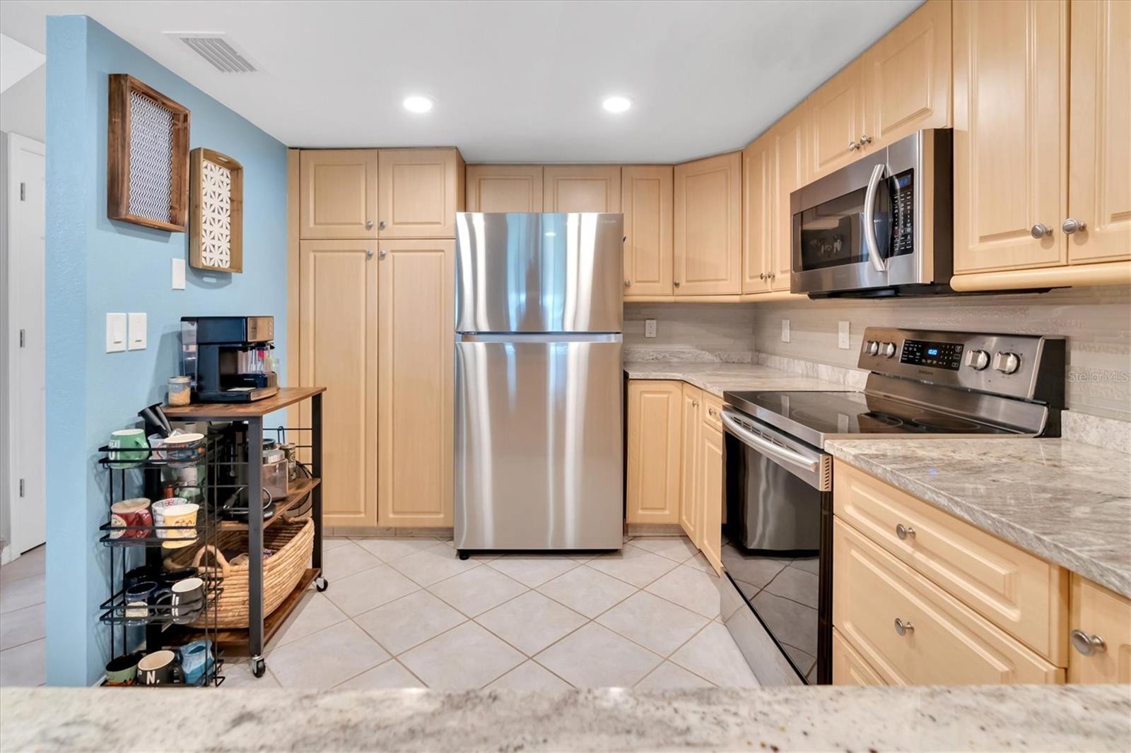 Nice size kitchen with granite counters and stainless steel appliances featuring a pantry!