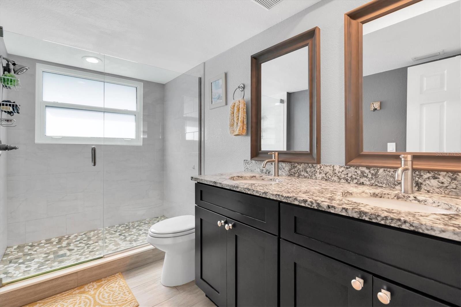 Updated master bath and glass shower with double sinks and granite counters!