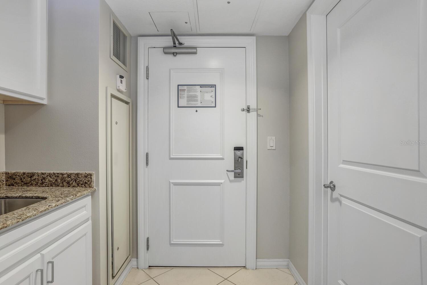 The cabana entrance is conveniently situated directly across the hallway. This location offers easy access and a straightforward route for guests.