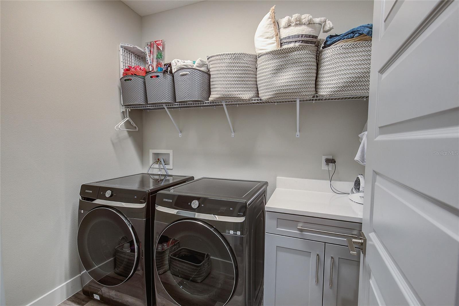 ROOMY LAUNDRY ROOM WITH CUSTOM CABINETRY