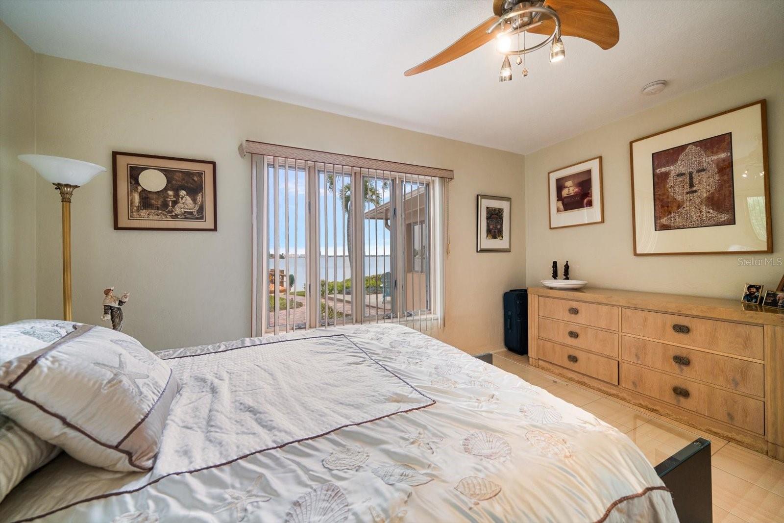 Guest bedroom overlooks yard and waterfront.