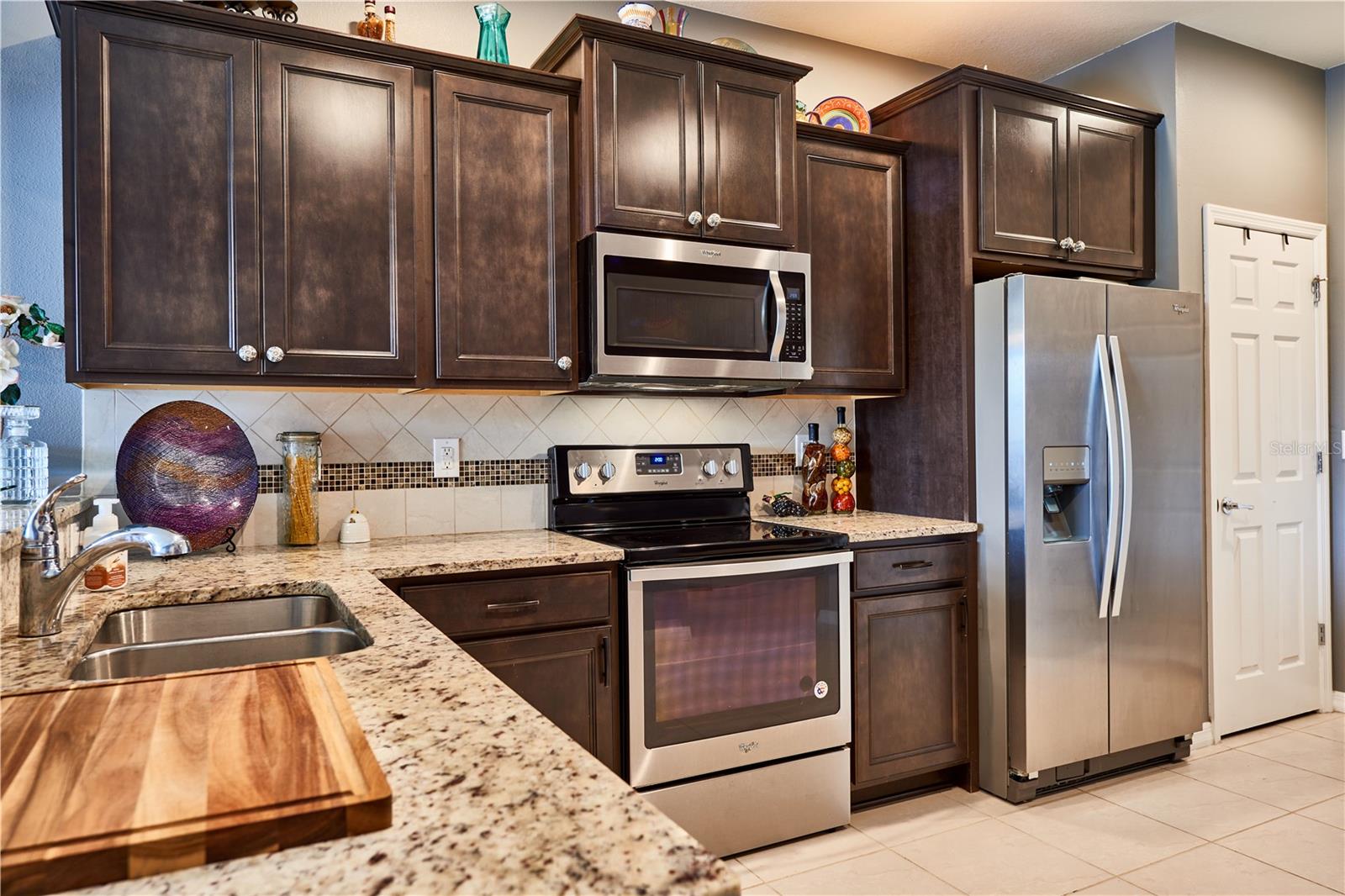 Glass and tile backsplash and stainless steel appliances
