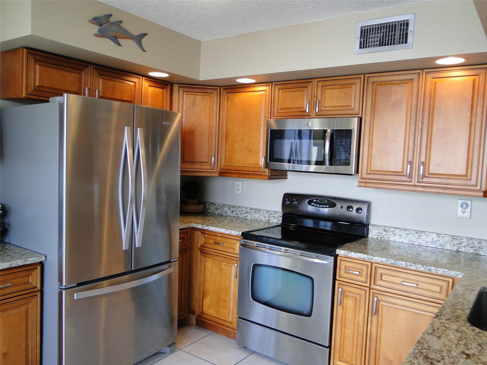 Stainless Steel Appliances.. Maple Glazed Wood Cabinets..