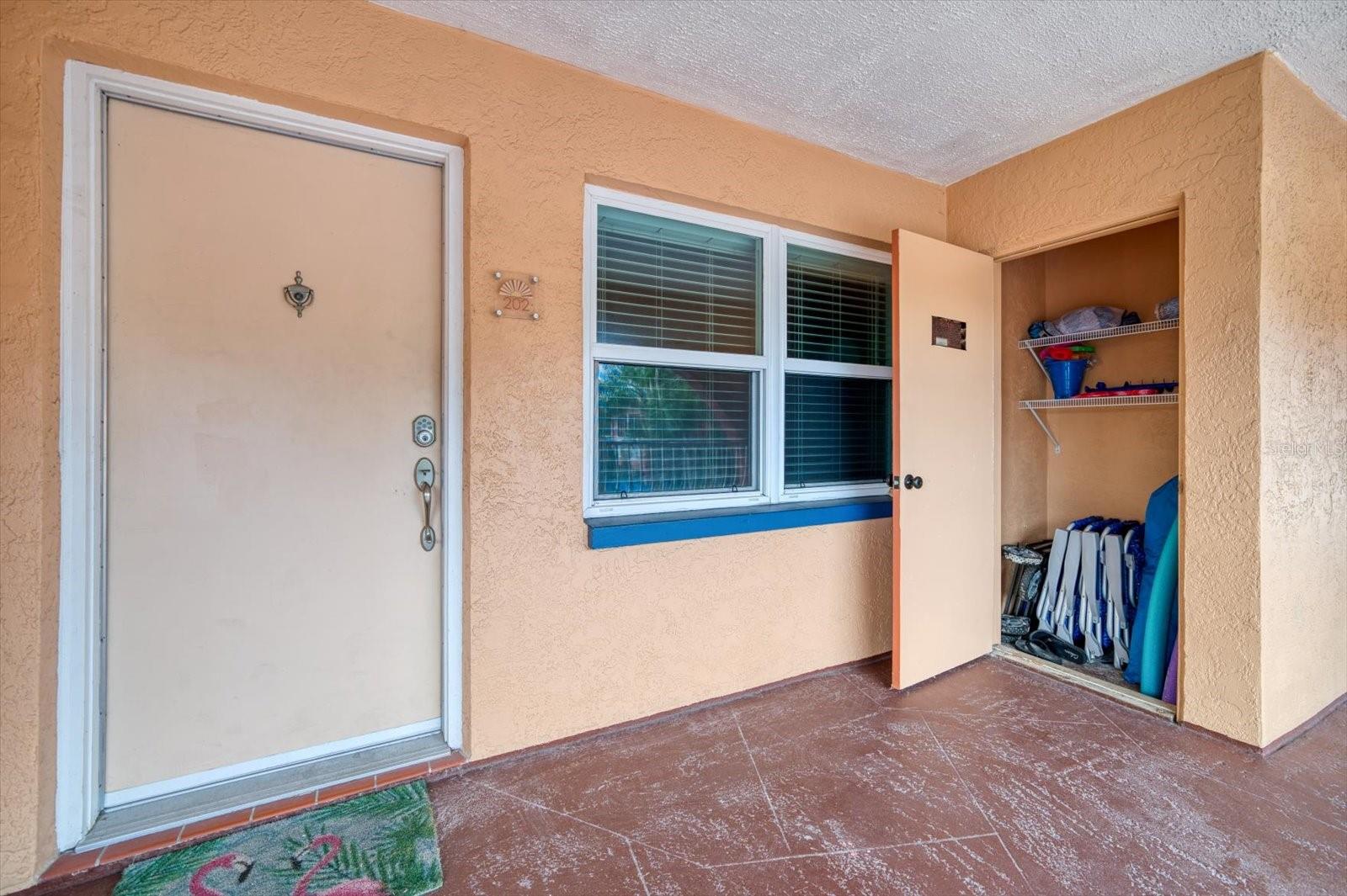 Front door and exterior storage closet. Convenient for beach chairs and umbrellas!