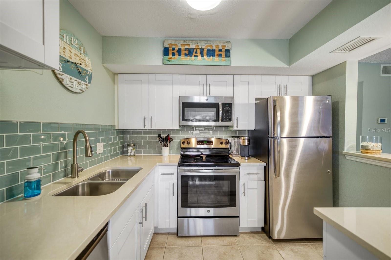 Newer Stainless steel appliances and elegant tile backsplash. Fully stocked with kitchenware and ready to rent!