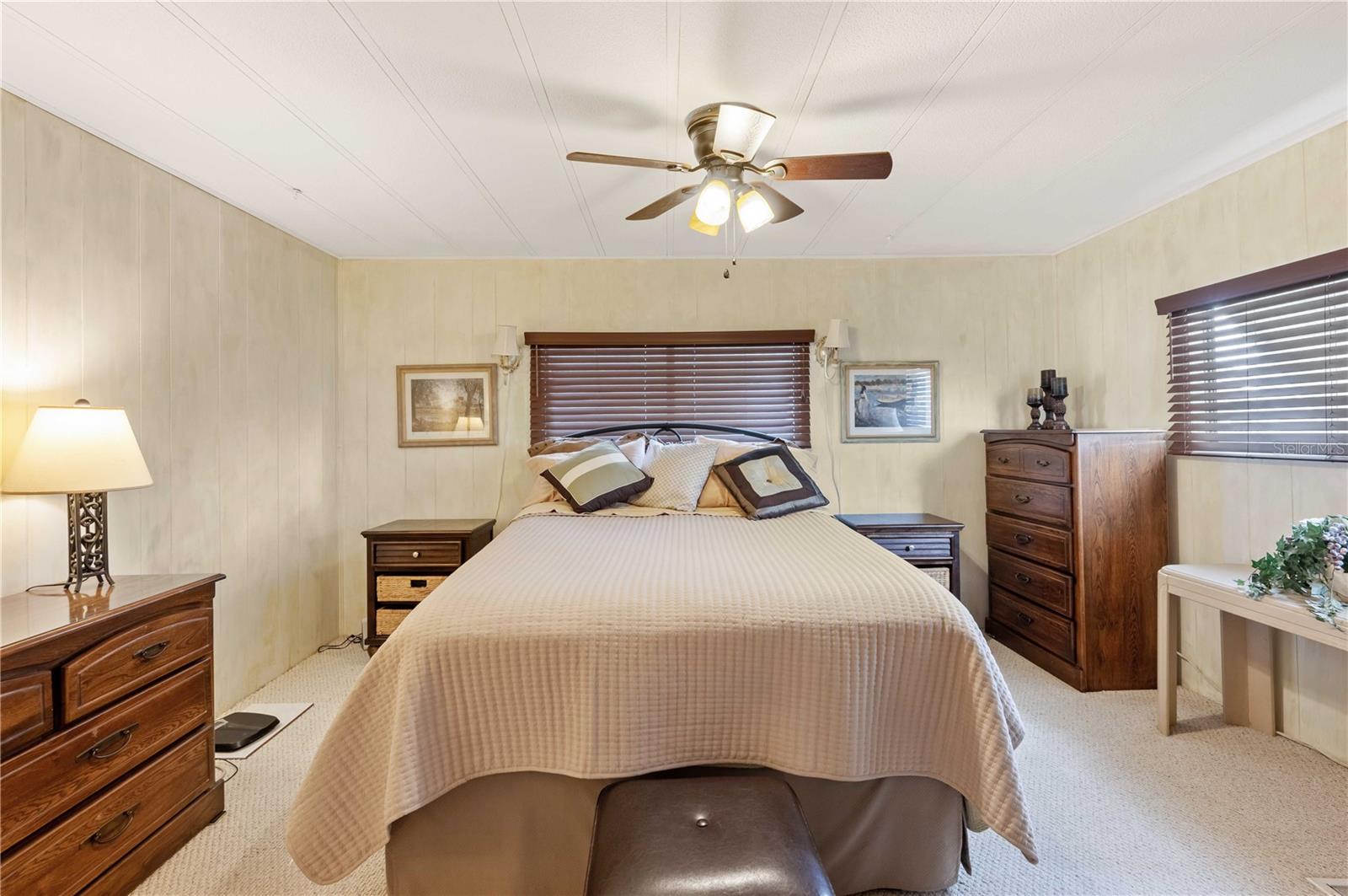 Main bedroom has Berber carpeting, ceiling fan, walk-in closet, and much more.