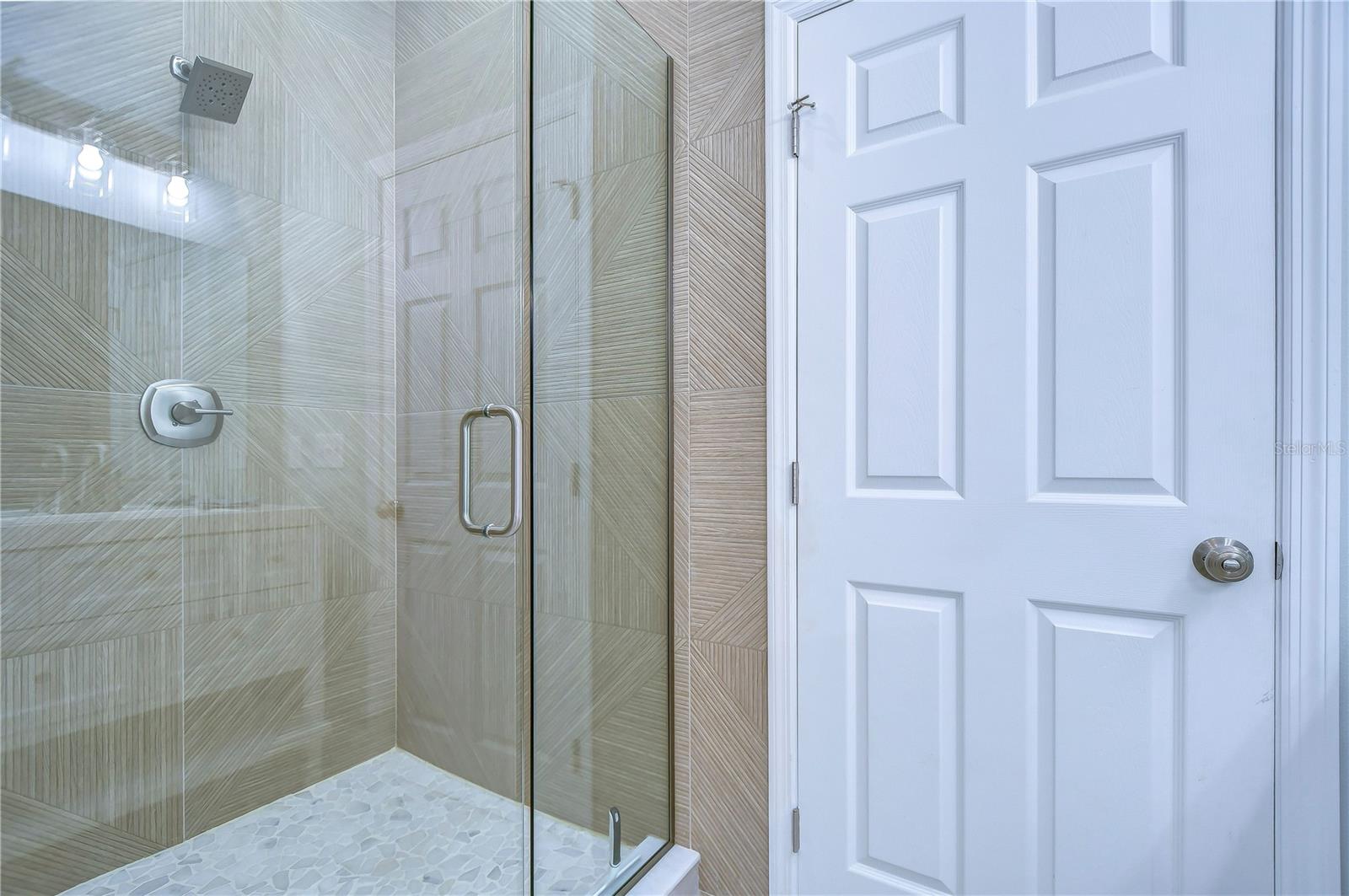 The beautiful tile in the large shower adds so much interest to the master bathroom.