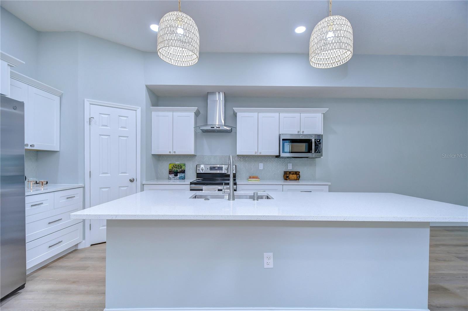 Tons of work space, an abundance of cabinets and drawers, and the walk-in corner panty are sure to delight the cook!