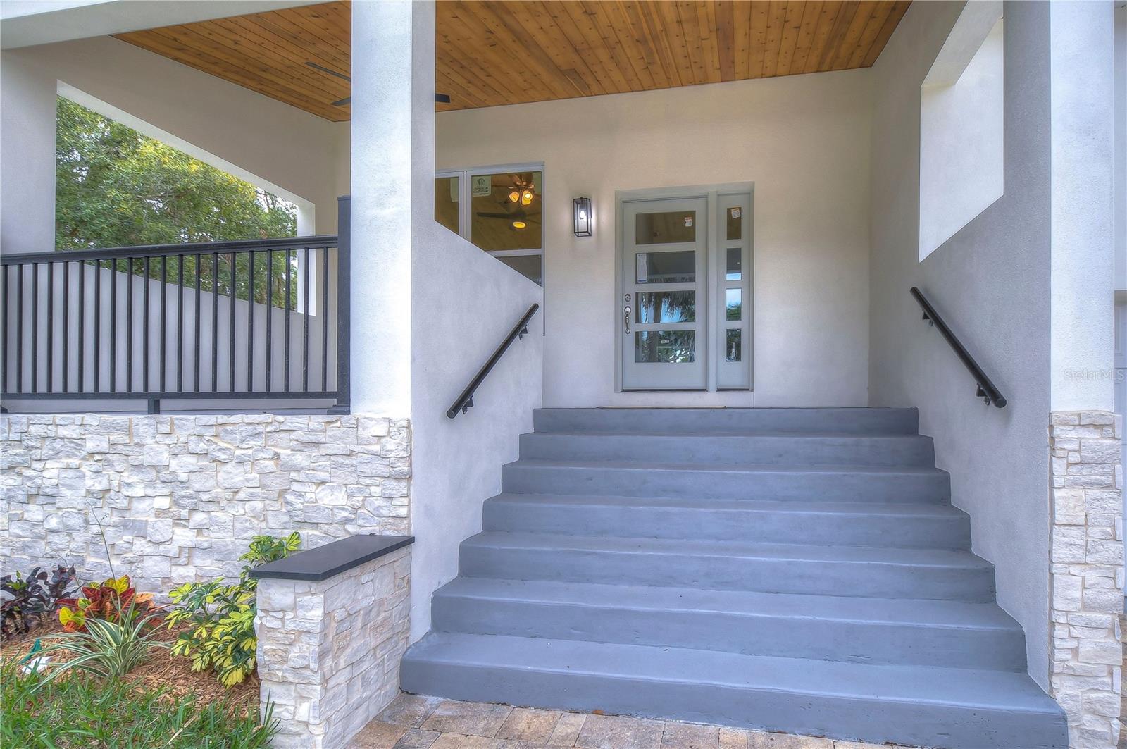 Wood, and Natural Stone Details add so much interest to this HOME! The contemporary style front door WELCOMES YOU IN.