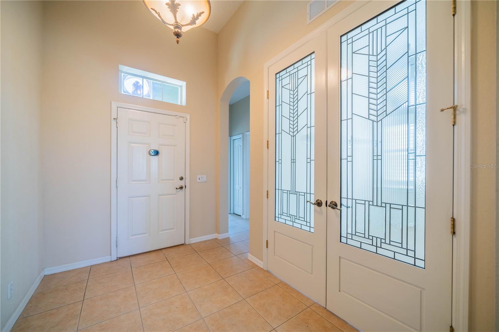 Foyer and stained glass doors to den