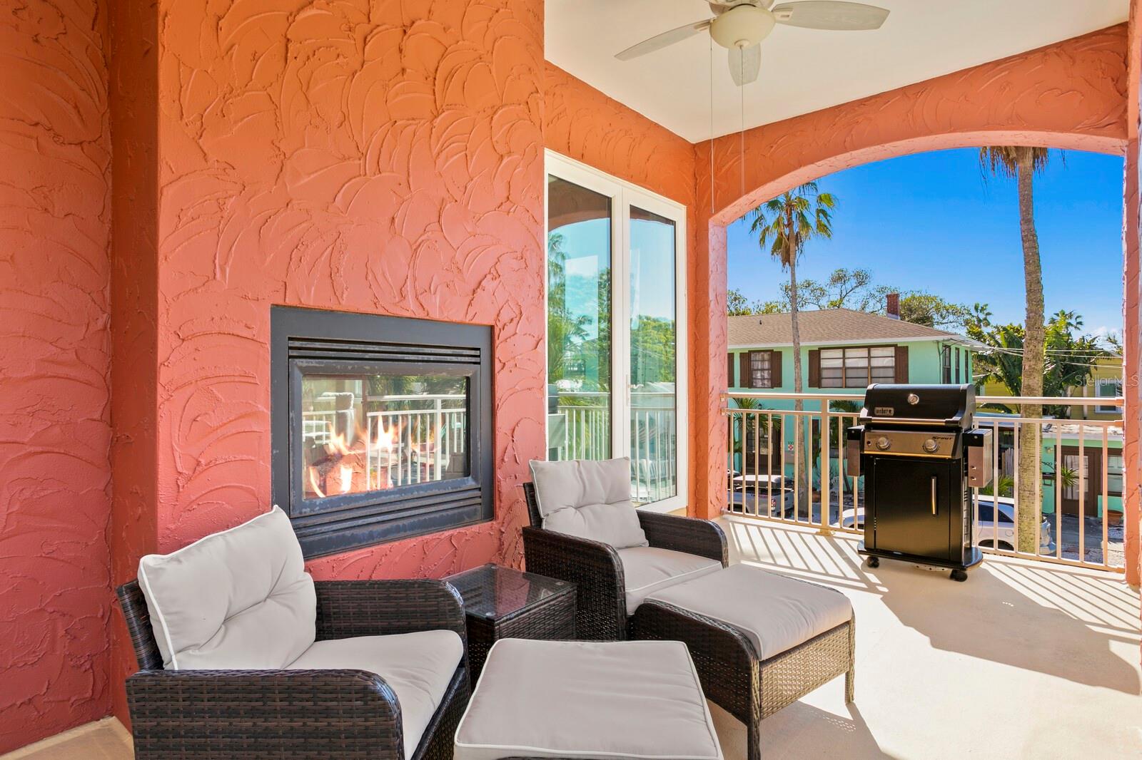 Balcony off living room with double sided fireplace