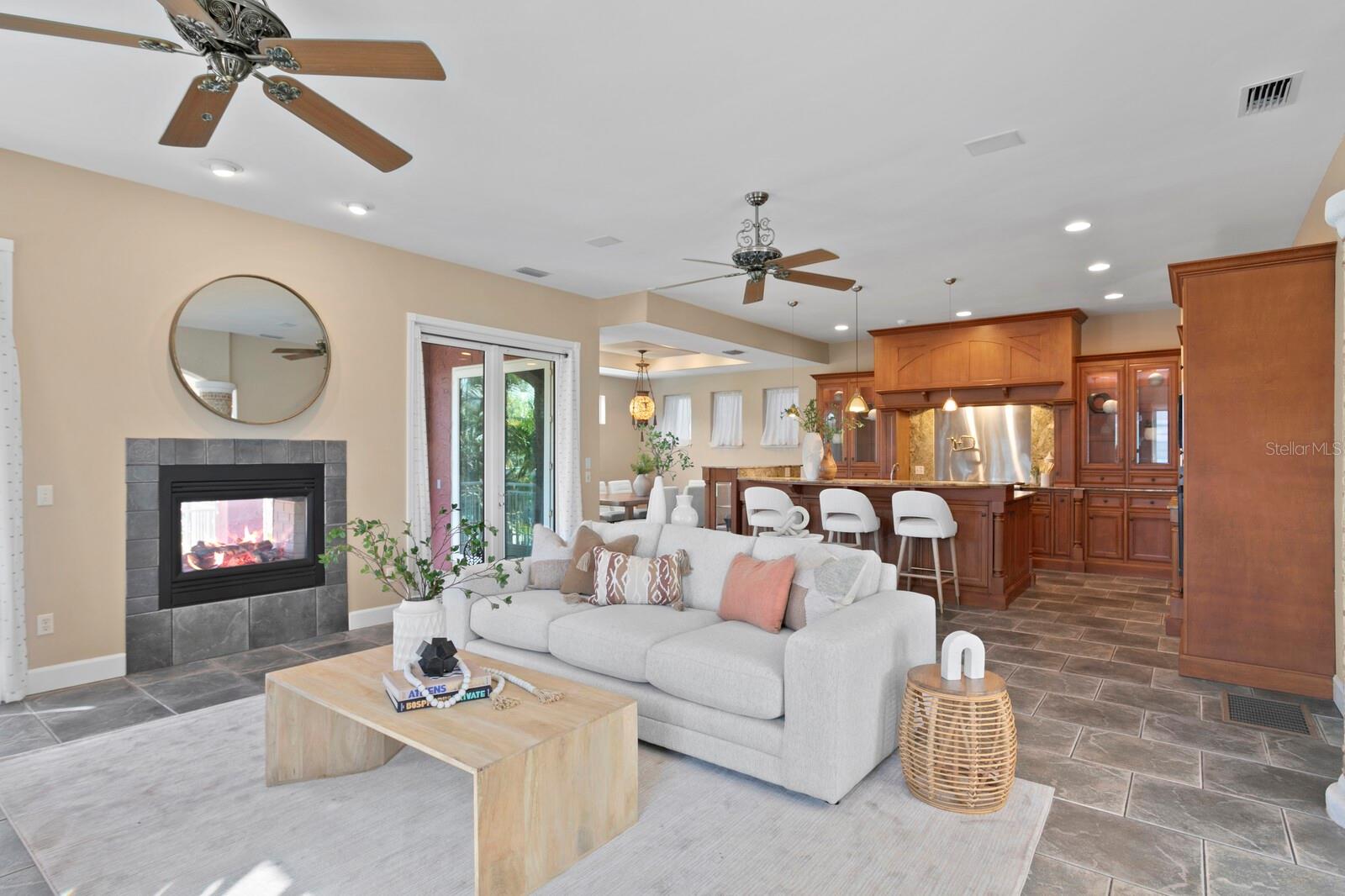 Spacious Living room with double sided gas fireplace with open concept to Chef's kitchen