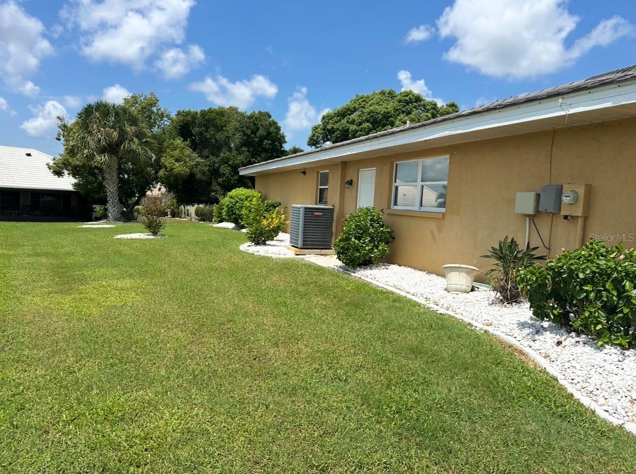 Left side of the home showing well maintained landscape