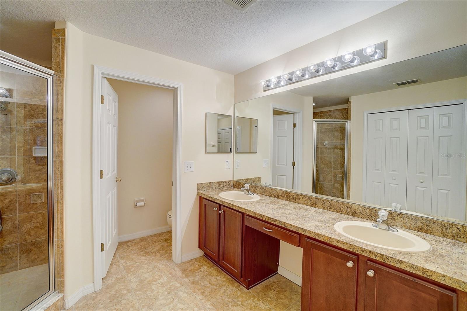 En-suite bathroom has separate shower and "water closet" along with dual sinks and lots of cabinet space.