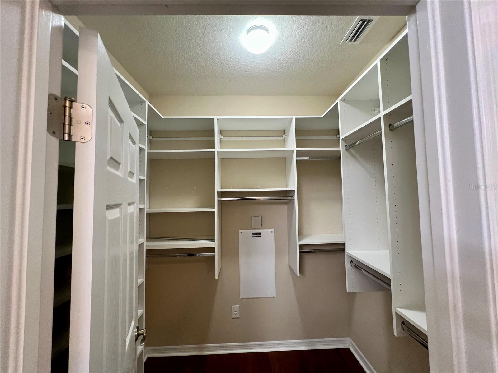 a very large walk in closet beyond the master bath