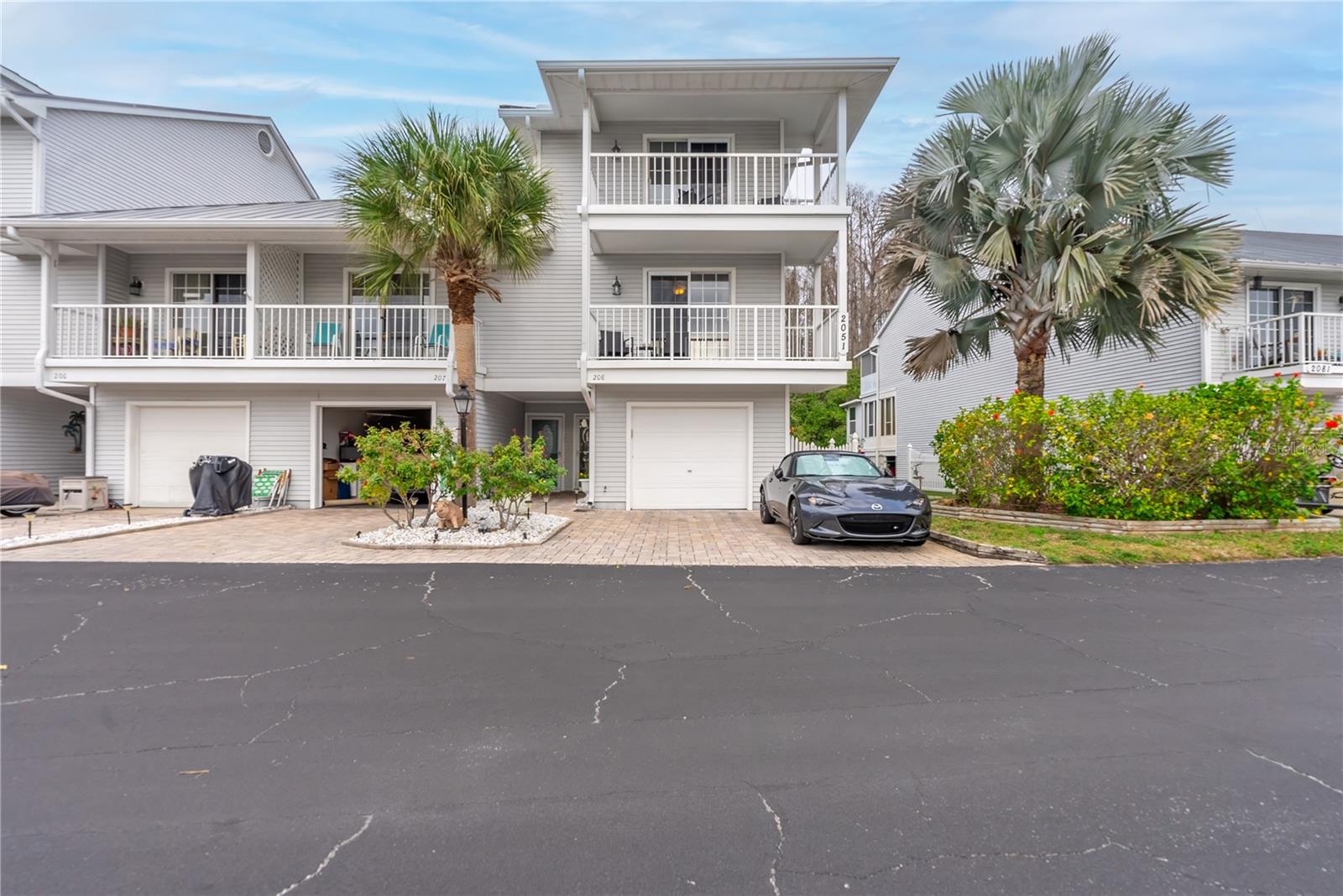 The Key West style condo has a paver driveway and a one car garage.