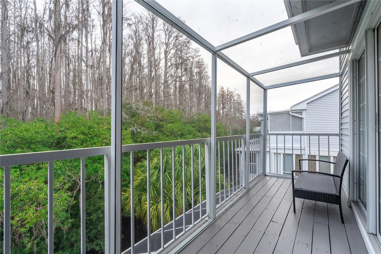 Stunning view outside the screened living room deck provides tranquil opportunities to watch the birds of Florida and birds that migrate here in the winter.
