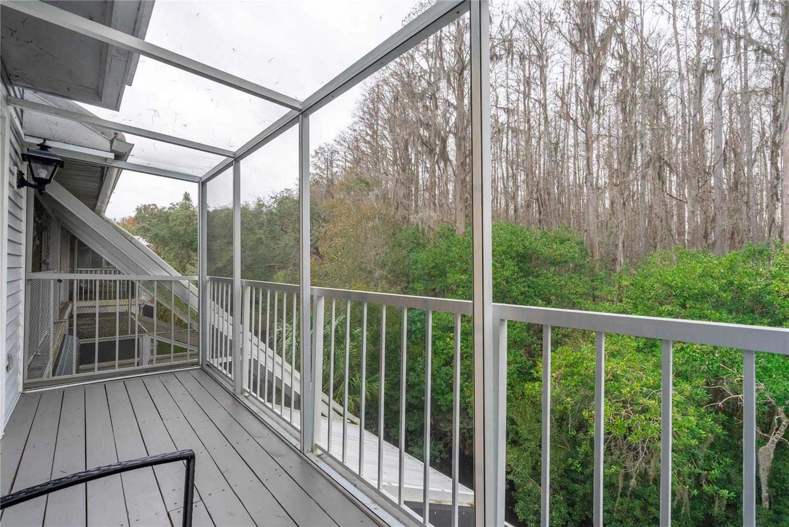 Another angle of the screened in deck that overlooks the creek. This is one of five balconies at this condo.