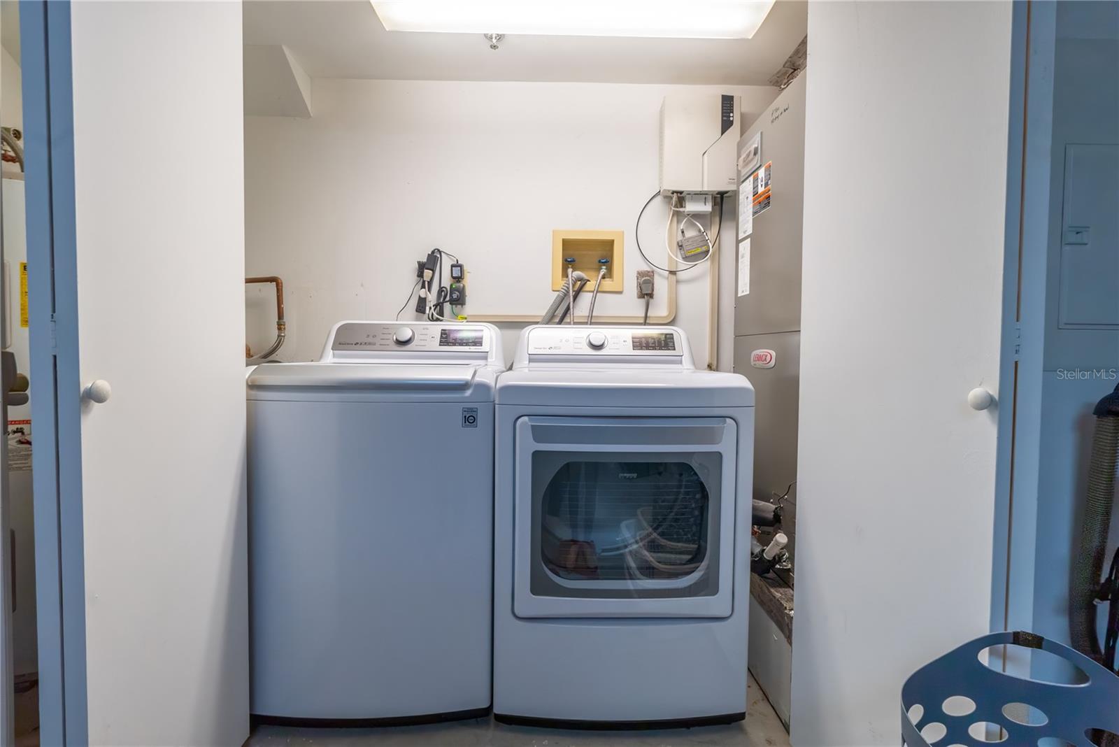 This washer and dryer will convey. They are tucked away in the garage.