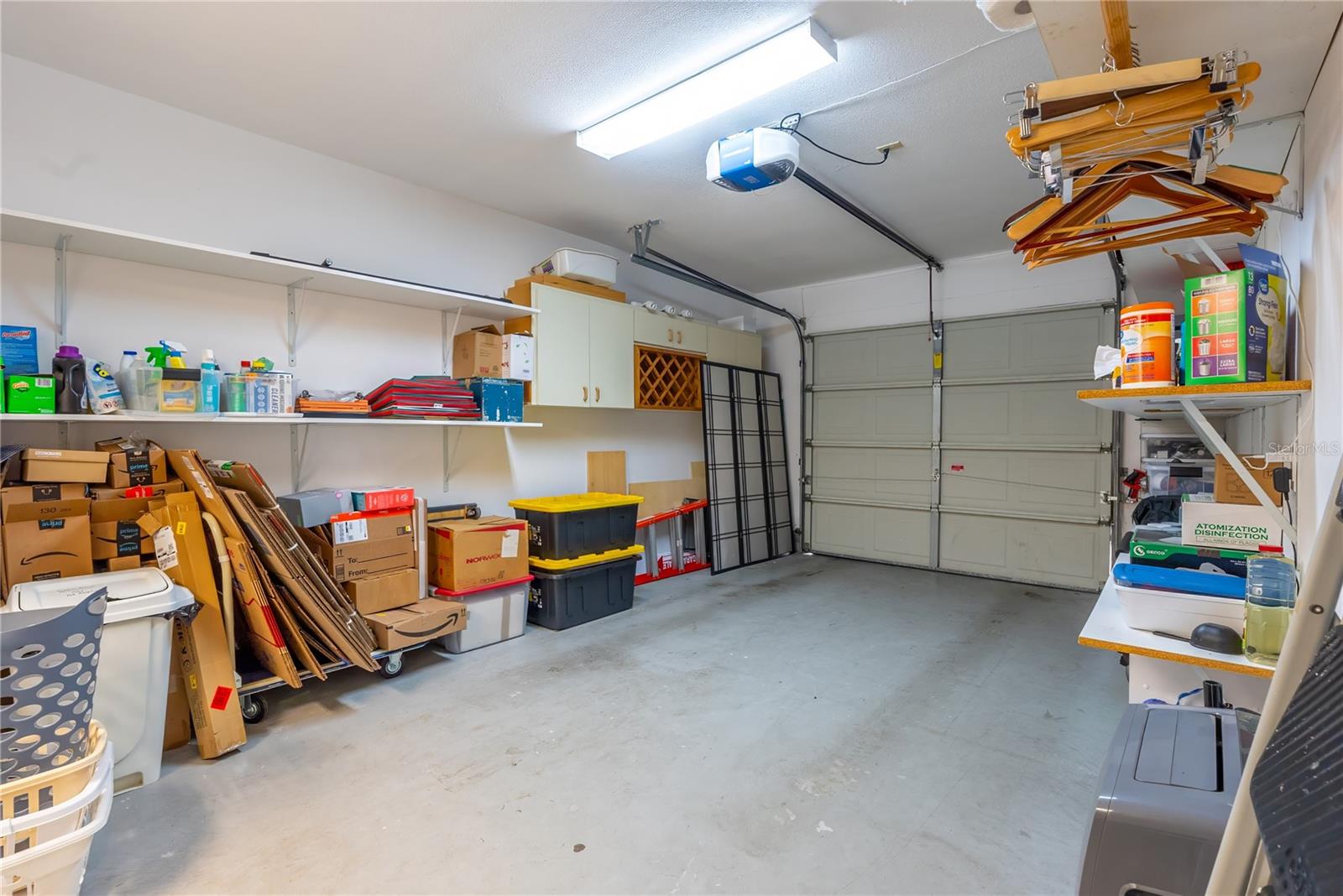 Shelving is on both sides of the garage.