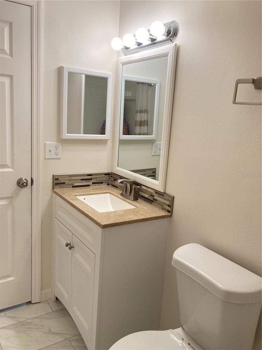 Hall bath updated with granite vanity