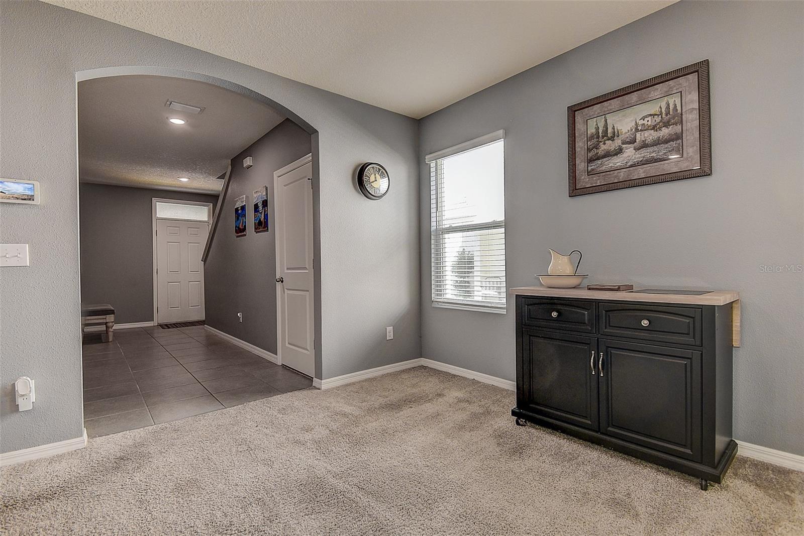 Large foyer with walk-in under stairs closet.