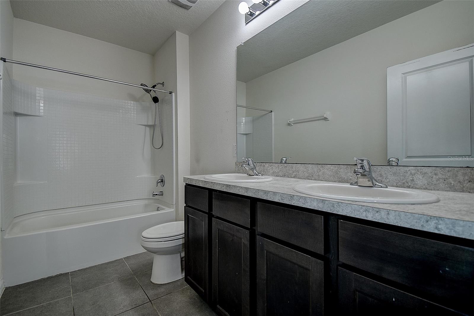 Bathroom 3. Dual sinks, tub/shower combo.