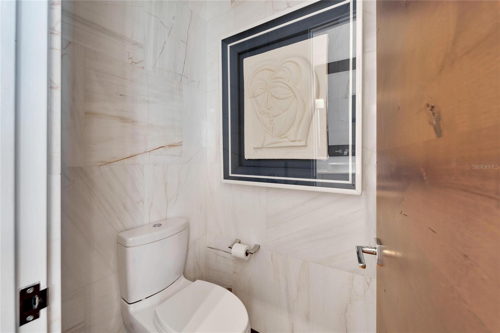 Private toilet with floor to ceiling marble