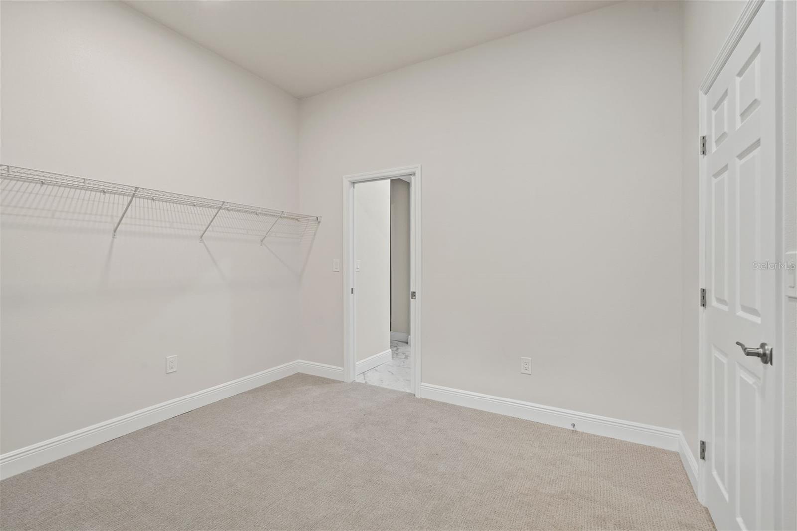 Expansive primary walk-in closet with access to the laundry room!