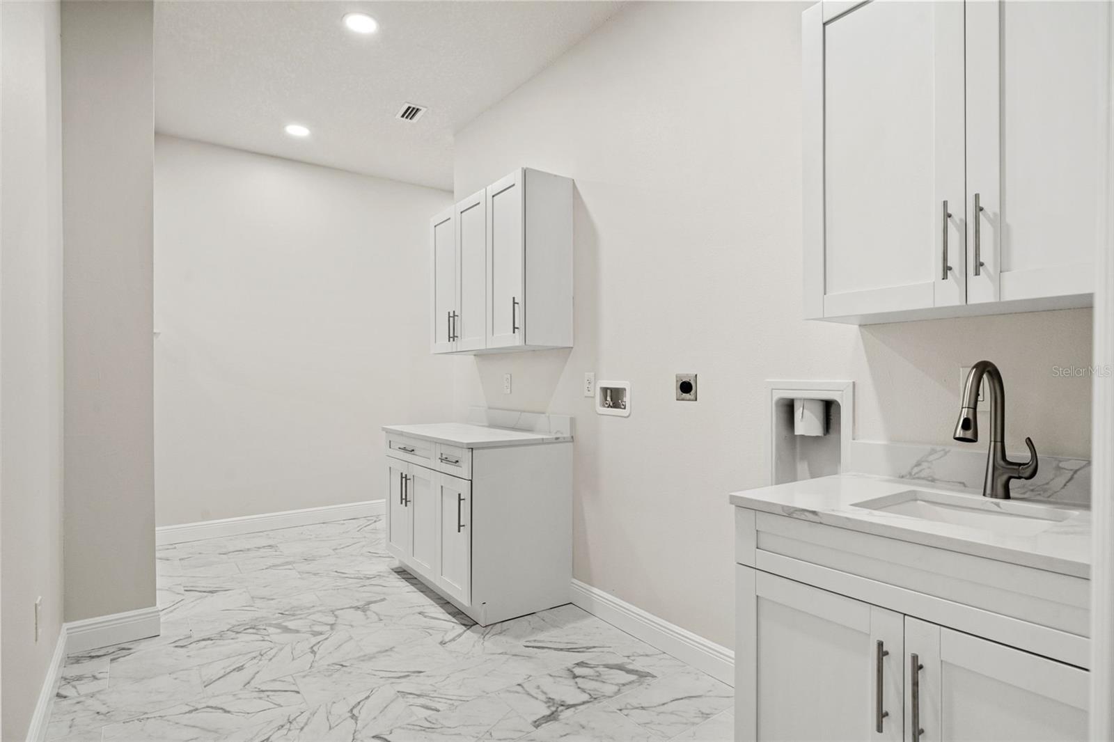 Laundry room with quartz counters and butler area