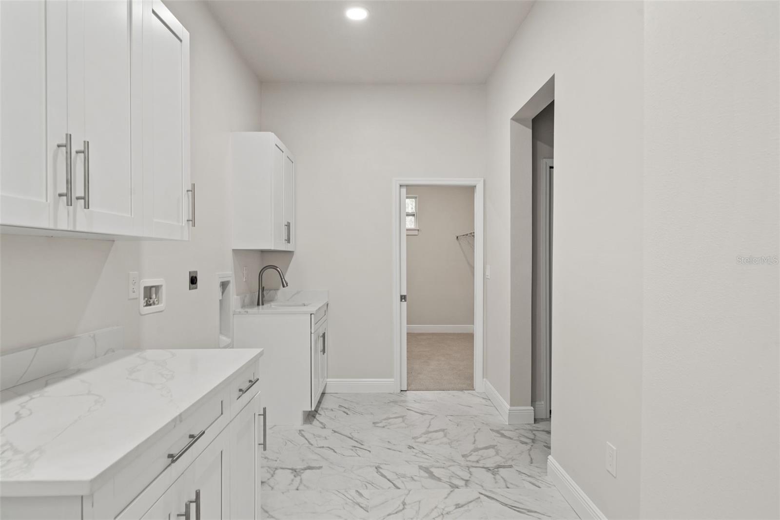 Laundry room with quartz counters and butler area