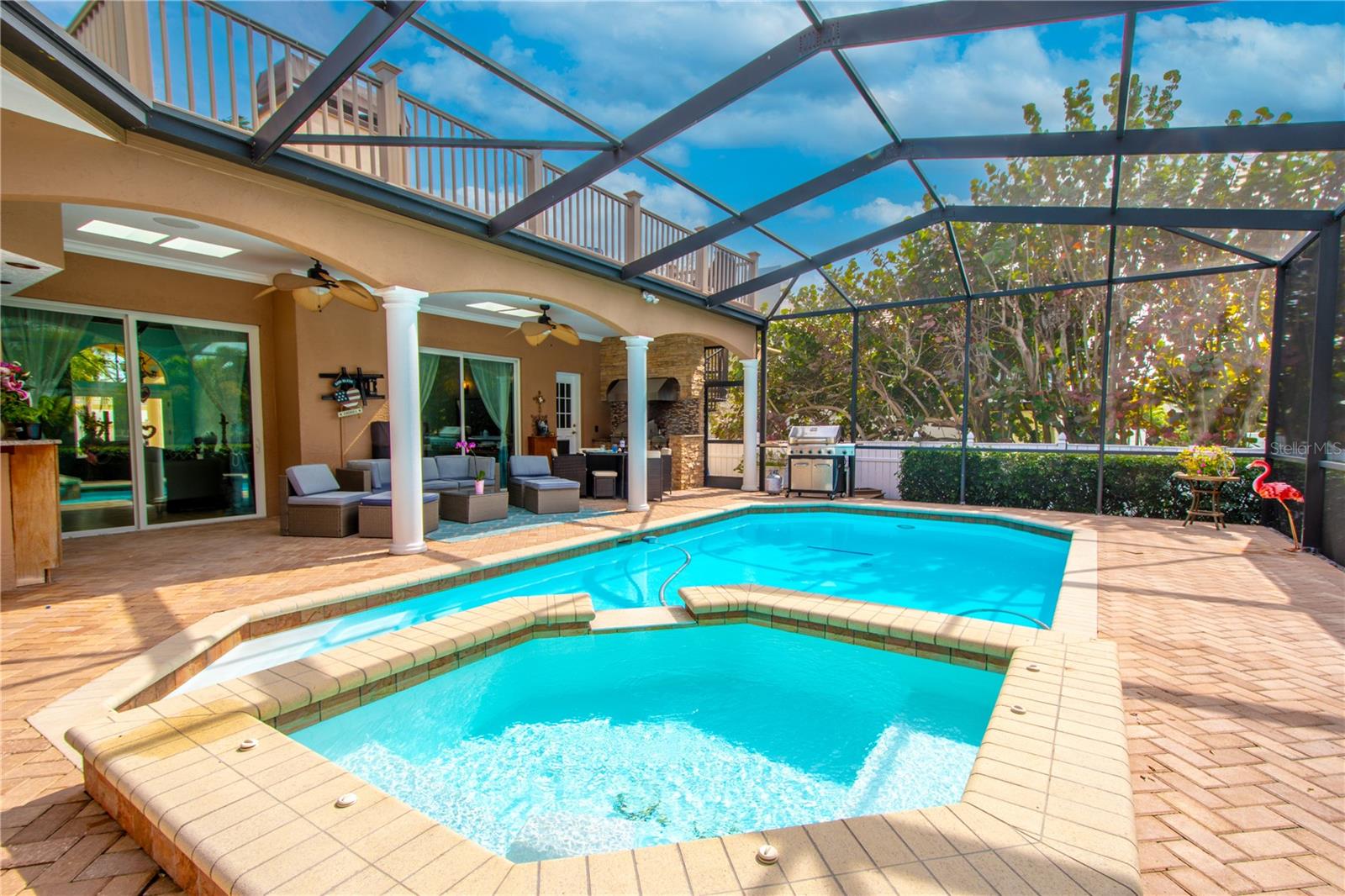 The pool and patio are designed for indoor/outdoor living.