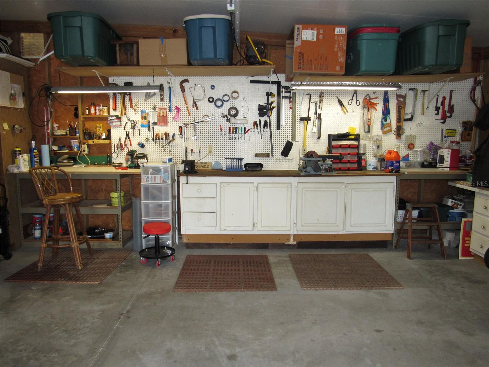 Two car garage with work bench & storage.