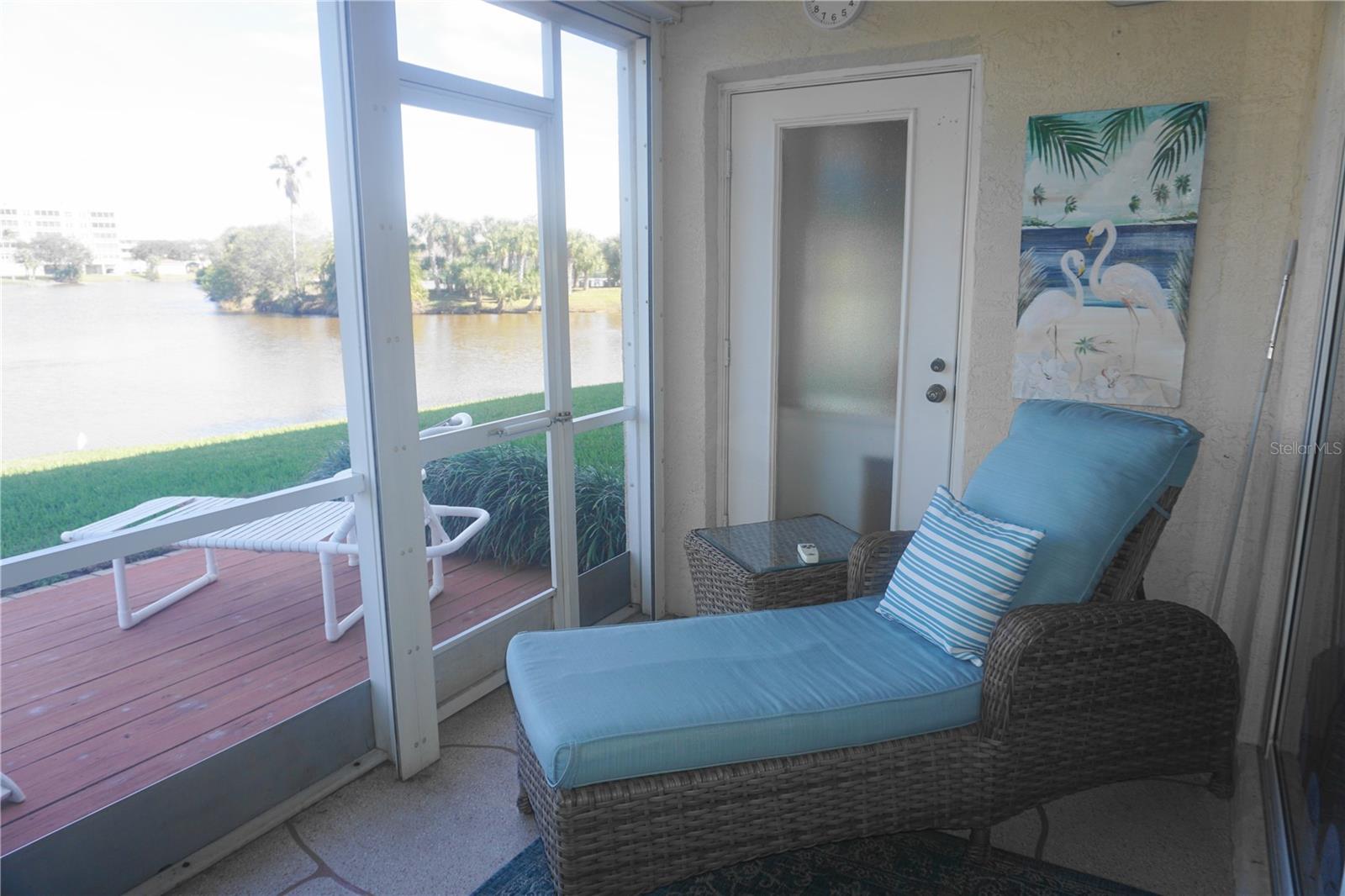 Screened lanai and outside deck with views of Snowy Egret Lake