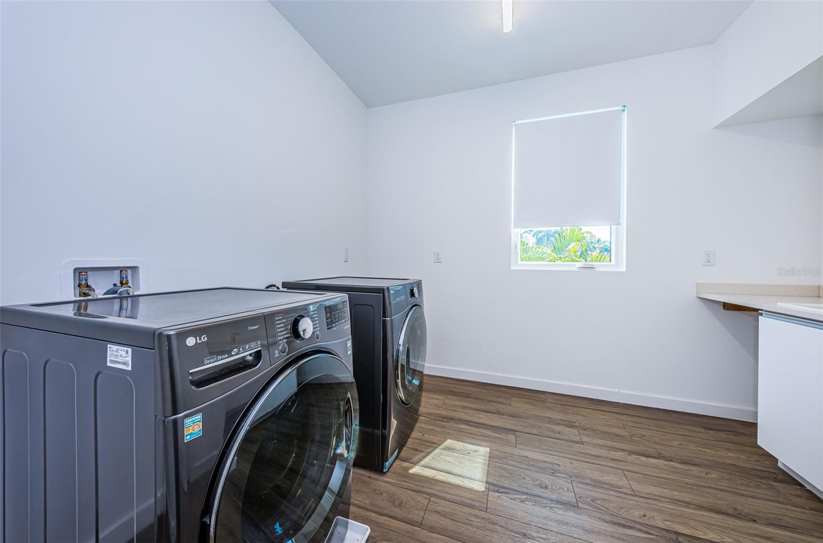Spacious upstairs Laundry Room with built-in sink and plenty of storage!
