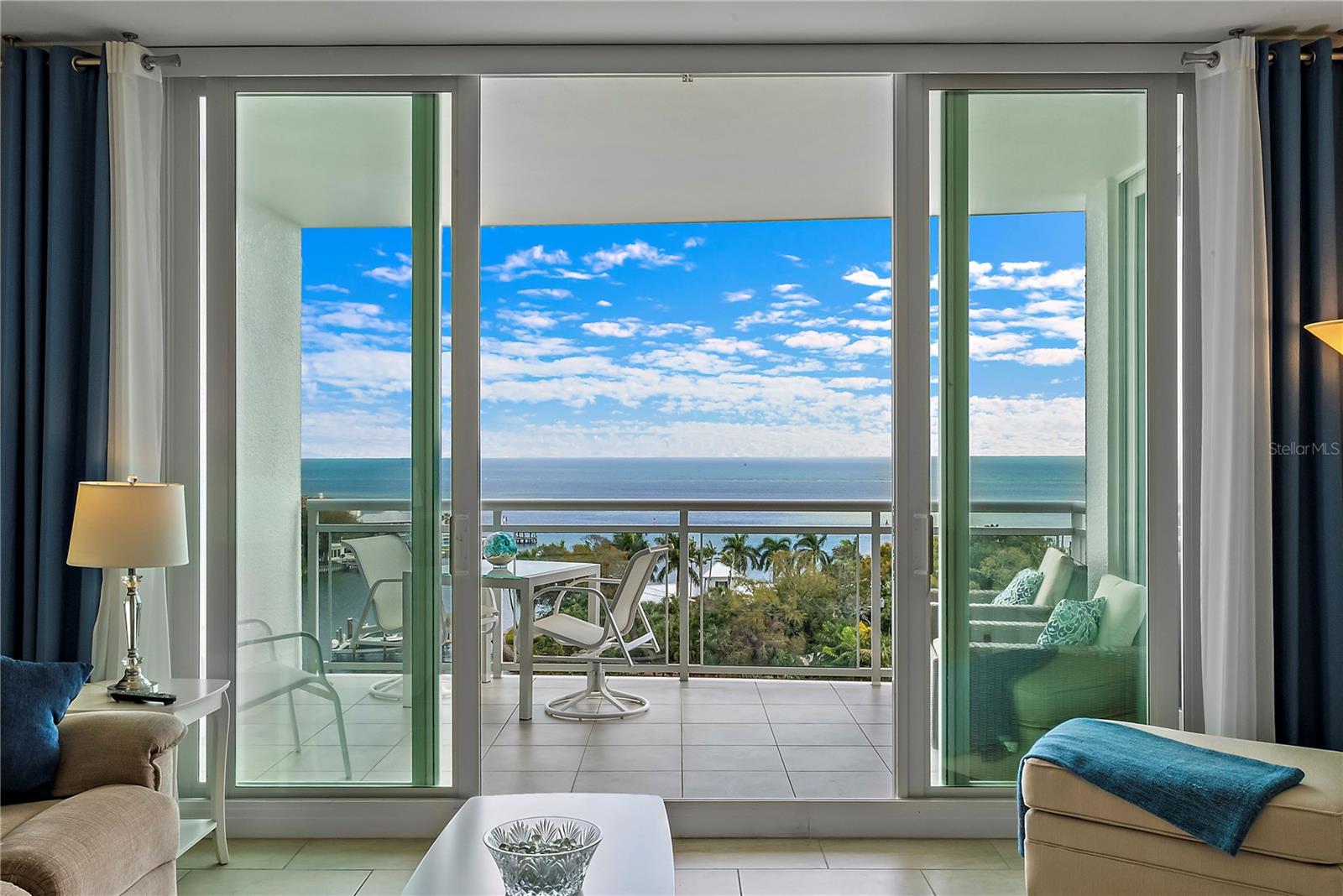 Panoramic water and views from Great Room which features Floor to Ceiling Sliding Doors
