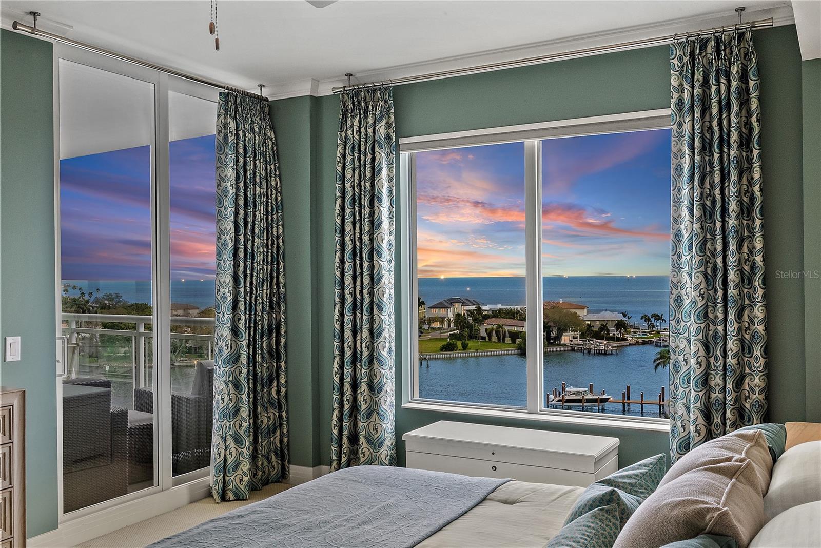 Tranquil Primary Suite with spectacular water views and sunrises. Floor to ceiling sliding glass doors open to private balcony.