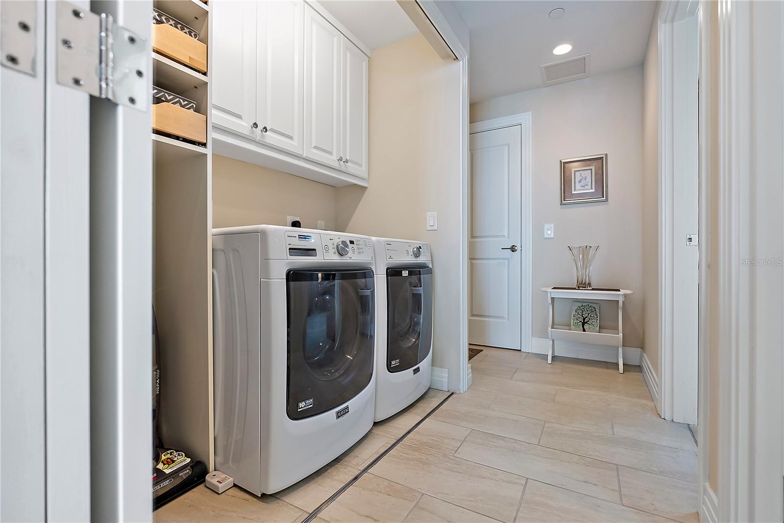 Laundry Alcove with deep cabinets and custom shelving for functionality.