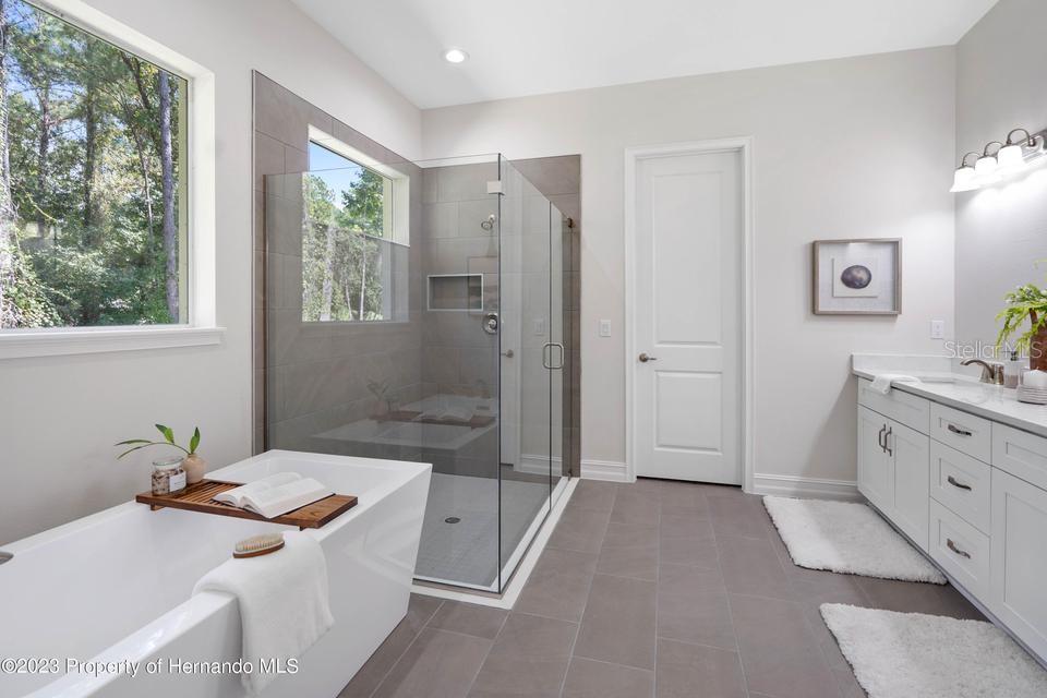 Primary bath frameless shower with stand alone soaking tub