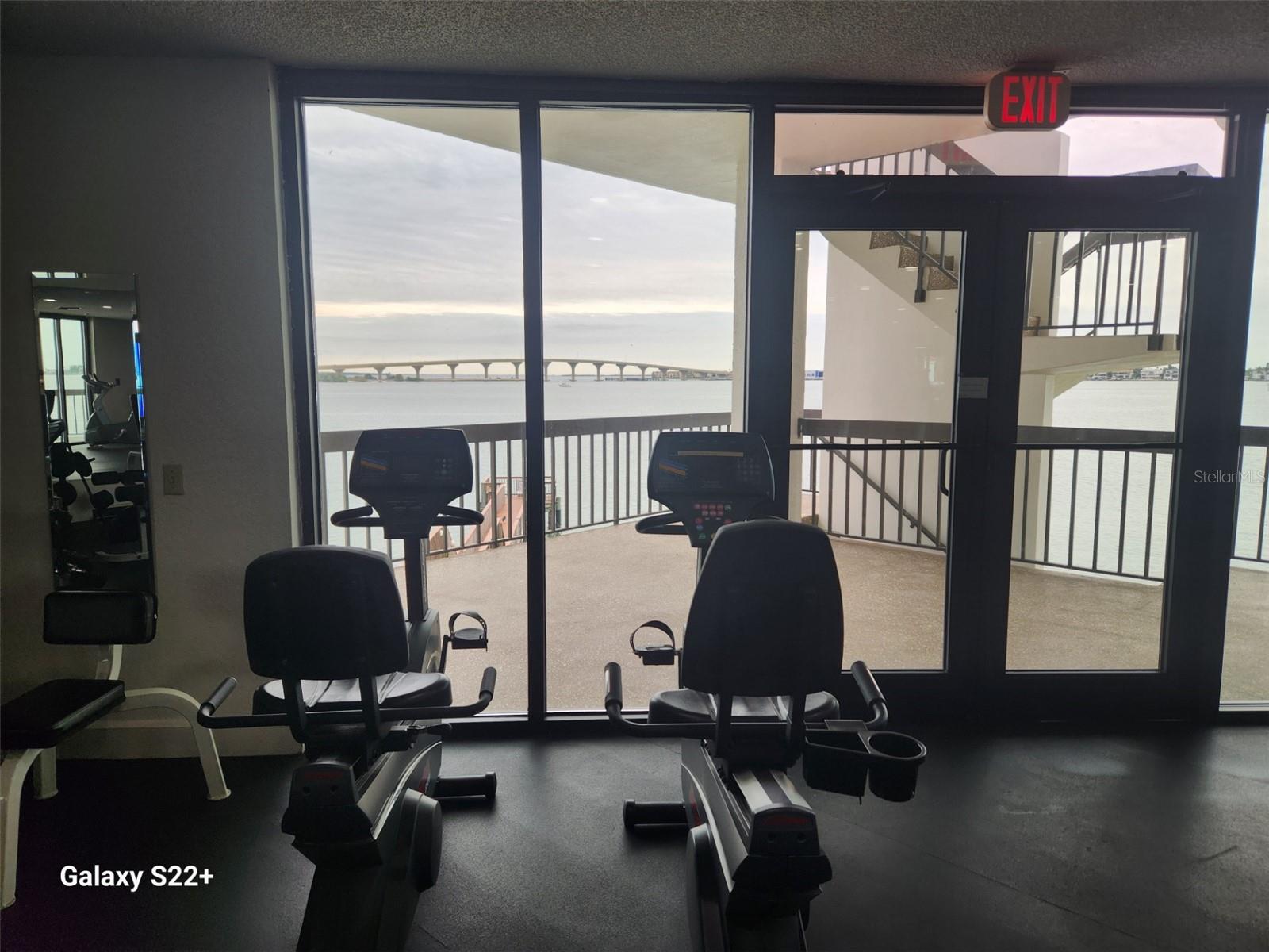 Gym has a view of the water while working out.