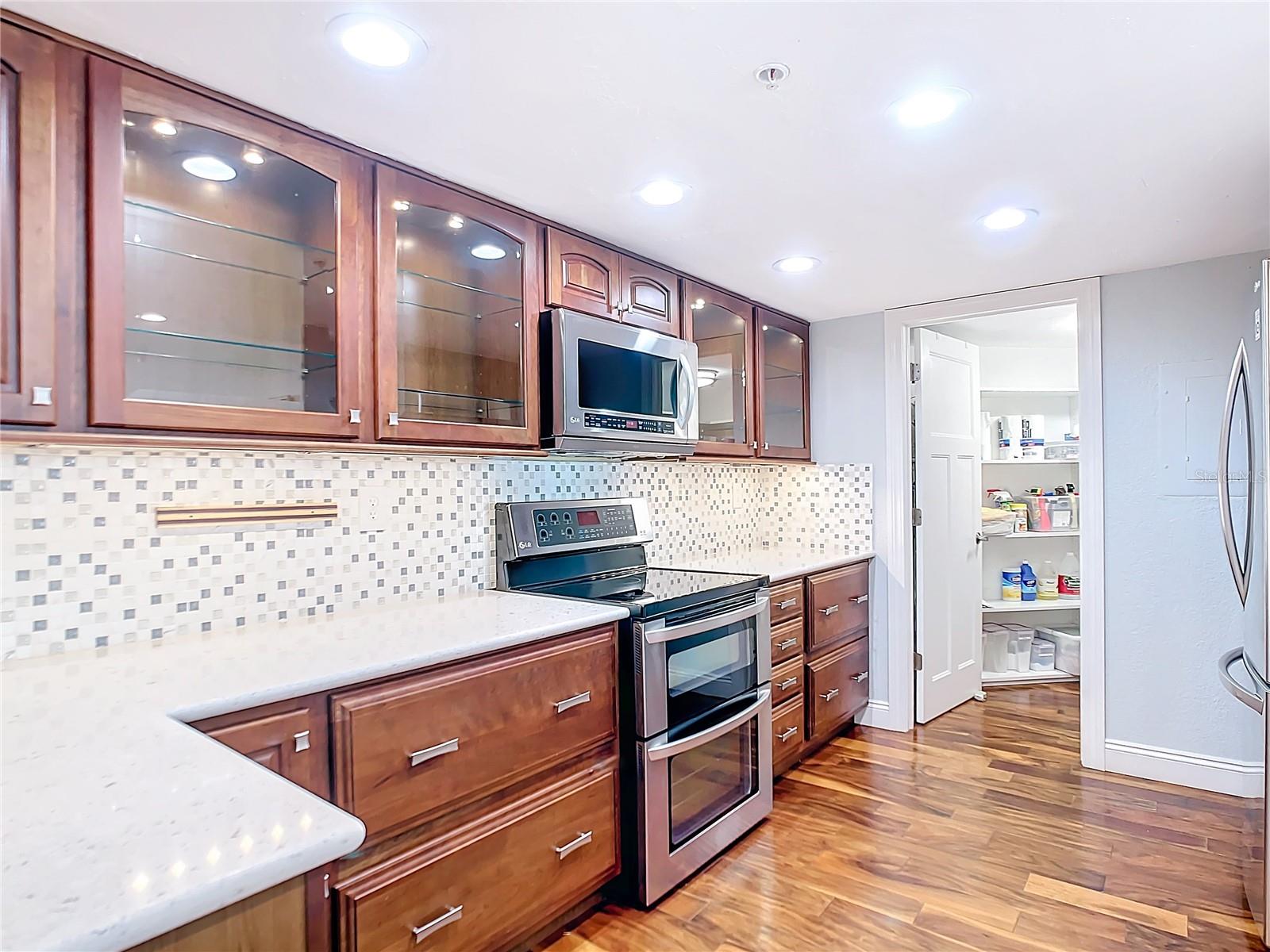 Large walk in pantry at end of kitchen. Custom cabinets that light up, soft close drawers.