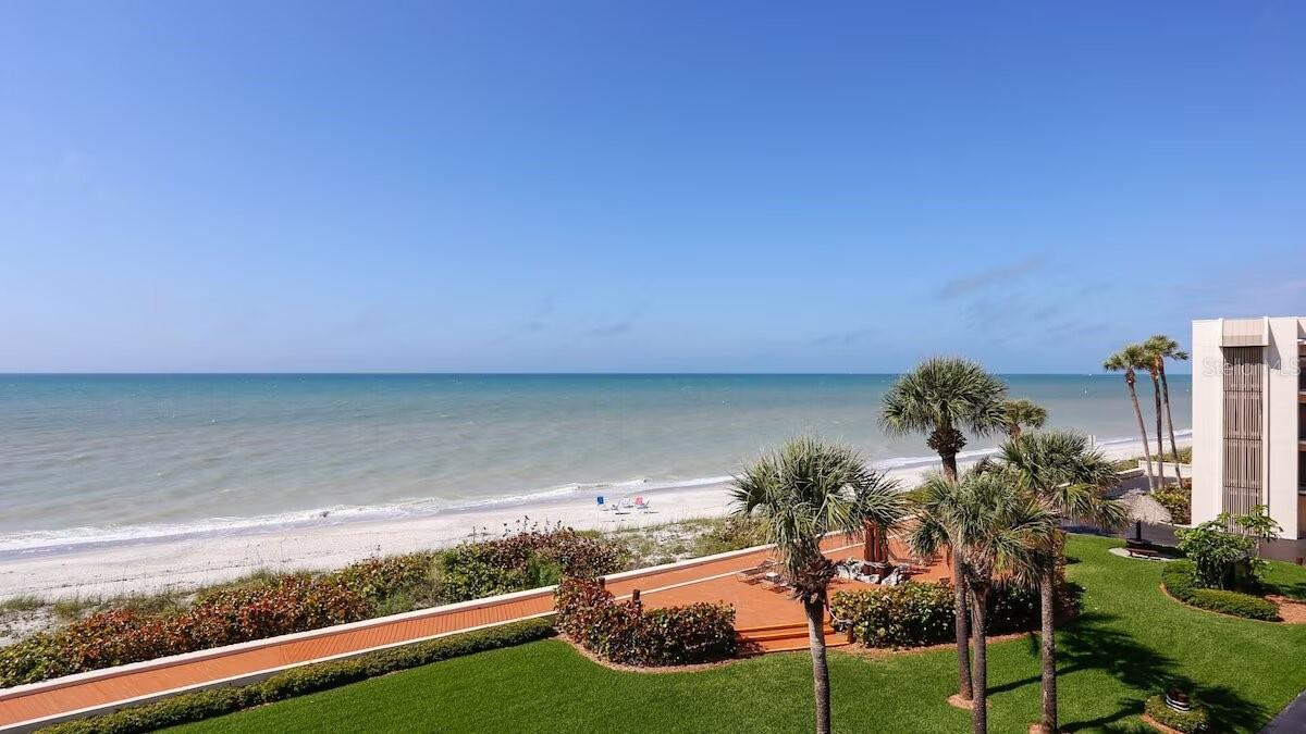View of Gulf of Mexico from balcony. Landscaping with lounging & boardwalk.