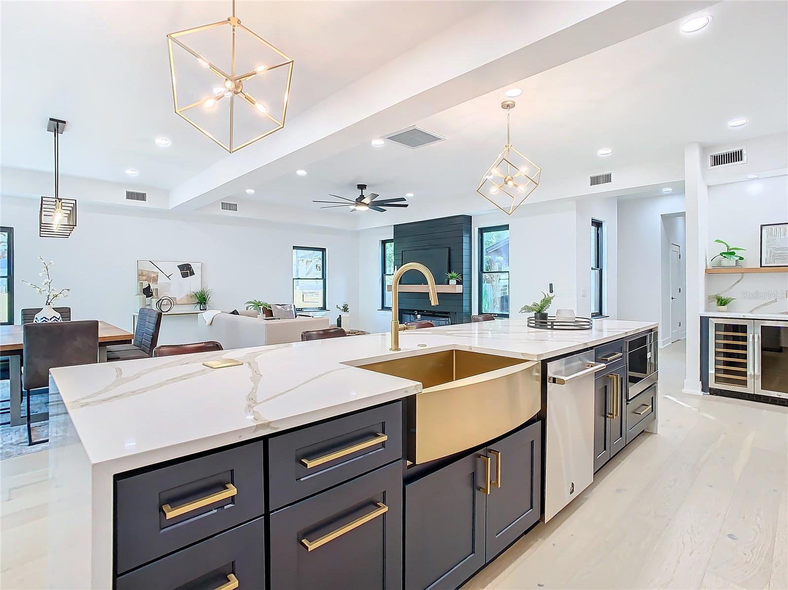 Chef kitchen with two-tone cabinetry, Jenn-Aire double ovens, below island microwave, two-tone soft close, hardware upgrades plus lighting, and vanishing USB charging stations set inside calacatta quartz counters, Floating Farm Sink and luxury lighting upgrades