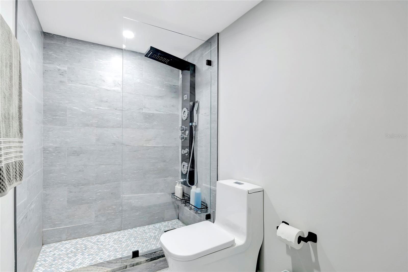 Marble tiled shower with multifunction shower system