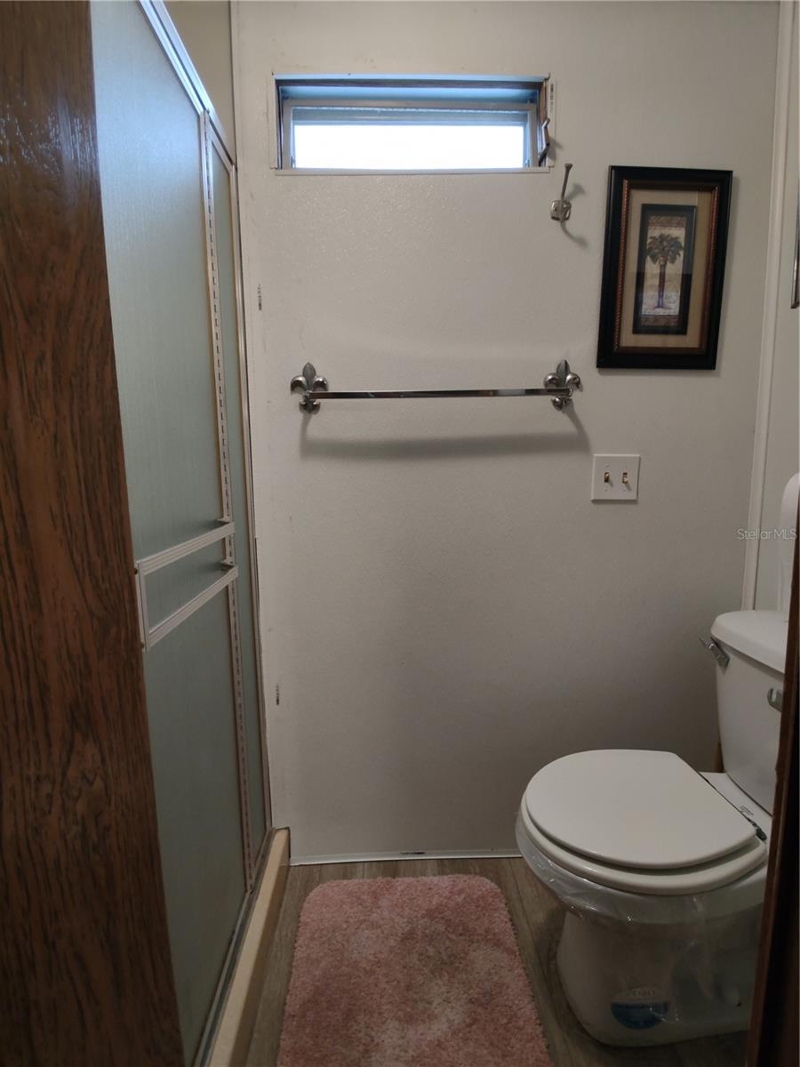 Guest bath offers a private water closet for the walk-in shower and commode.